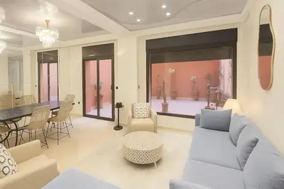a living room with a couch and a dining room at Duplex apart with parking by Sabor Voyage in Marrakech