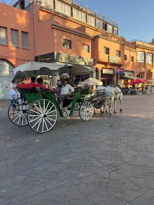 a horse drawn carriage on a city street at Riad traditionnel Kham's centre Marrakech in Marrakech