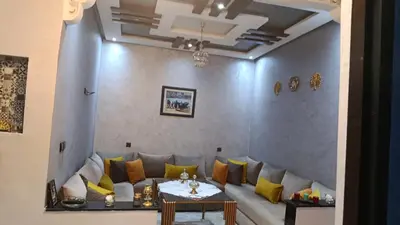 a living room with a couch with yellow pillows at Afaq marrakech in Marrakech