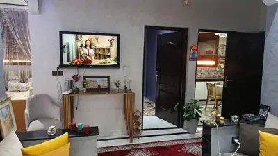 a living room with a tv on the wall at Afaq marrakech in Marrakech