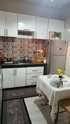 a kitchen with a table and a refrigerator at Afaq marrakech in Marrakech