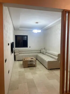 a living room with a couch and a table at Nour 5 Marrakech Appartement in Marrakech