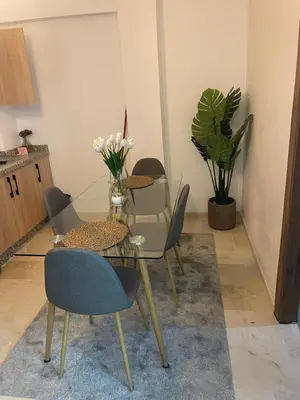 a dining room with a glass table and chairs at Nour 5 Marrakech Appartement in Marrakech