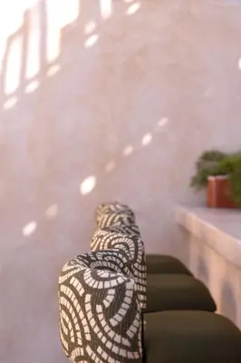 a black and white chair sitting next to a staircase at Riad Sumud in Marrakech