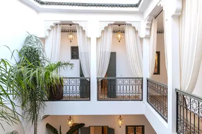 a view from the second floor of a building with white columns at Riad Sumud in Marrakech