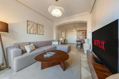 a living room with a couch and a table at Luxury Flat Private Rooftop & Heated Pool Guéliz in Marrakech