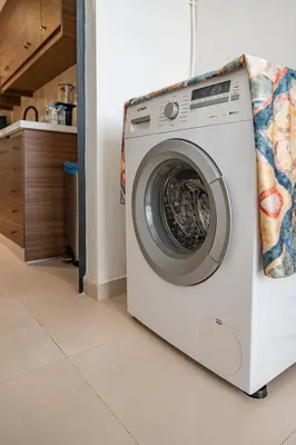 a washing machine is sitting in a kitchen at Luxury Flat Private Rooftop & Heated Pool Guéliz in Marrakech