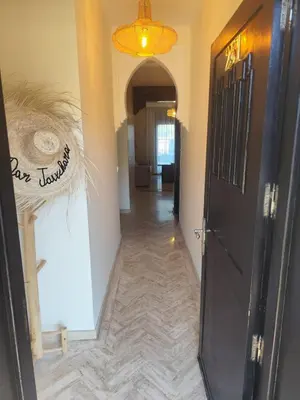 a hallway with a black door and a hallway with a hallwayngth at Résidence Atlas Golf Marrakech in Marrakech