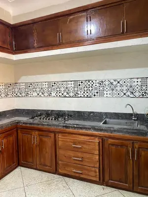 a kitchen with wooden cabinets and a sink at Majorelle City Apartment in Marrakech