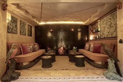 a living room with a couch and two tables at Riad Kalemat & Spa in Marrakech