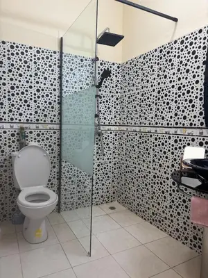 a bathroom with a toilet and a glass shower at Comfortable stay - Marrakech style in Marrakech