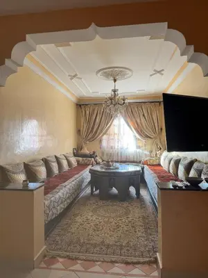 a living room with a couch and a table at Comfortable stay - Marrakech style in Marrakech