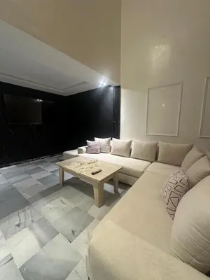 a living room with a white couch and a coffee table at le duplex spacieux comfort in Marrakech