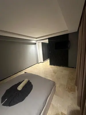 a room with a bed with an umbrella on it at le duplex spacieux comfort in Marrakech