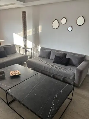 a living room with a couch and a table at Menara Garden Gueliz Marrakech in Oulad Akkou
