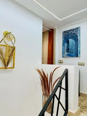 a staircase in a house with a painting on the wall at RIAD El Ma in Marrakech