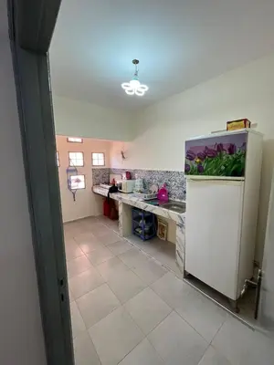 an empty kitchen with a counter and a refrigerator at 3Br in heart of Marrakech 15min from downtown in Marrakech