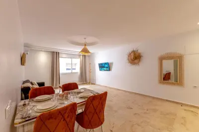 a dining room with a table and chairs at Appartement moderne trés securisé a gueliz au centre ville in Marrakech