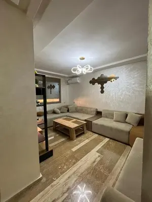 a living room with a couch and a table at Appartement moderne 5 min au centre de ville proche du gueliz in Marrakech