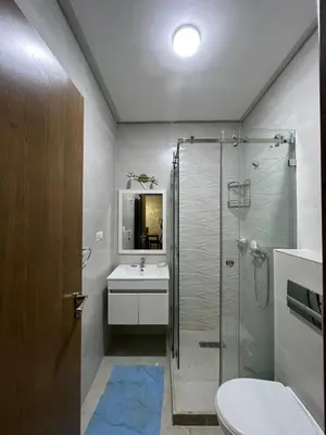 a bathroom with a shower and a sink and a toilet at Appartement moderne 5 min au centre de ville proche du gueliz in Marrakech