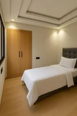 a bedroom with a large white bed and a cabinet at Marrakech Mood in Marrakech