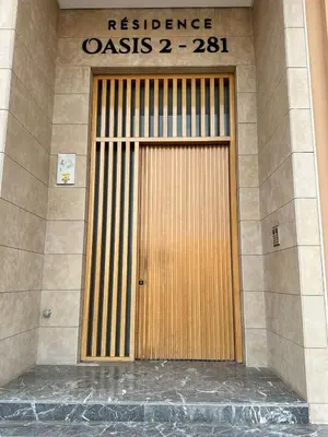 a wooden door on a building with a sign on it at Marrakech Mood in Marrakech