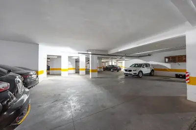 an empty parking garage with cars parked in it at Sunny Luxe 2BR Heaven Apt Wi-Fi, Balcony & Pool in Marrakech