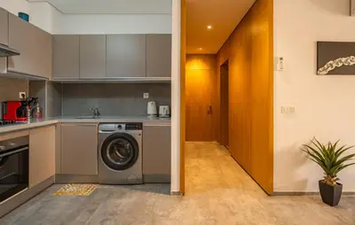 a kitchen with a washing machine in a kitchen at Modern Hivernage Appt New 2-BR w Pool & Terrace in Marrakech
