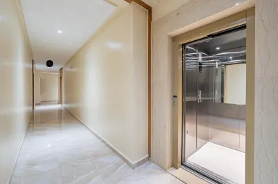 an empty corridor with a glass door in a building at Le Grand Chic in Marrakech