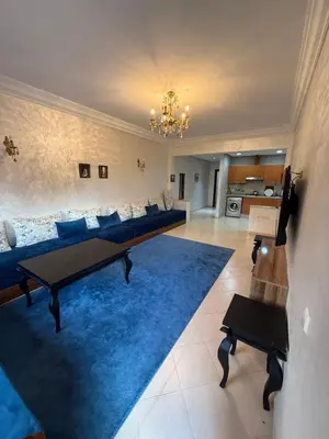 a living room with a couch and a blue rug at Kech in Marrakech