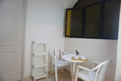 a small white table and chairs in a room at Cozy studio au Centre Marrakech in Marrakech