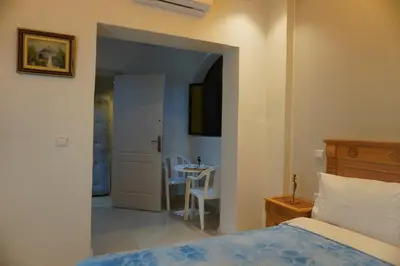 a bedroom with a bed and a table with a chair at Cozy studio au Centre Marrakech in Marrakech