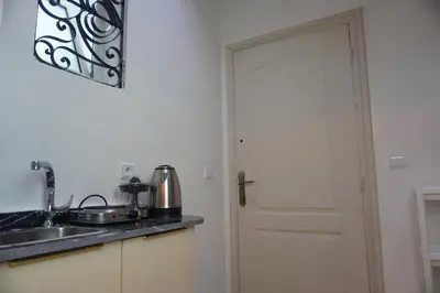 a kitchen with a sink and a door at Cozy studio au Centre Marrakech in Marrakech