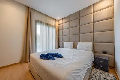 a bedroom with a bed with a blue towel on it at Luxury Stay in Prestigia Garden and Pool in Marrakech