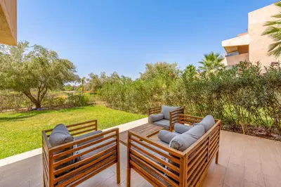 two chairs and a table on a patio at Luxury Stay in Prestigia Garden and Pool in Marrakech