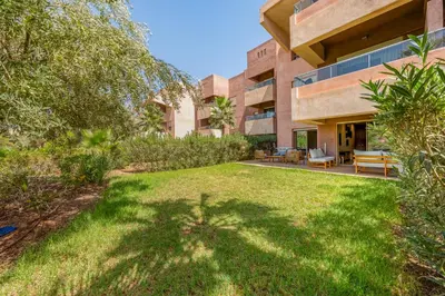 an exterior view of a building with a yard at Luxury Stay in Prestigia Garden and Pool in Marrakech