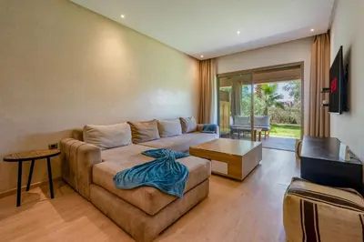 a living room with a couch and a table at Luxury Stay in Prestigia Garden and Pool in Marrakech