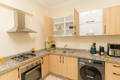 a kitchen with a washing machine and a sink at Luxury Apartment Hivernage 5 minutes from Jemaa El Fna in Marrakech