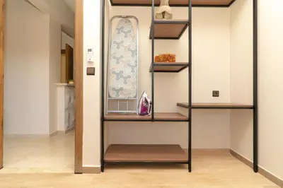 a room with wooden shelves and a wall at Luxury Apartment Hivernage 5 minutes from Jemaa El Fna in Marrakech