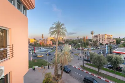 a view of a city street with palm trees and cars at Studio au cœur de Guéliz à 5 min de Jemaa el-Fna in Marrakech