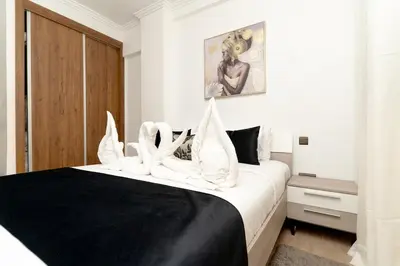 a bedroom with a large bed with white pillows at Studio Hivernage 2 munit a la gare in Marrakech