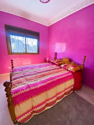 a bedroom with a bed in a pink room at Nice Apartment in Marrakesh in Marrakech