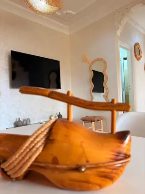 a wooden boat sitting on a table in a room at A haven of light & sweetness in Marrakech