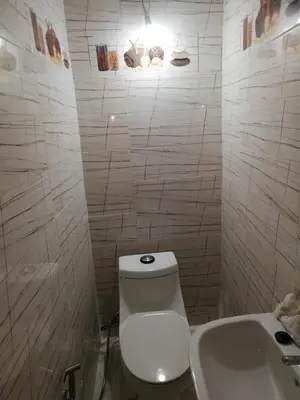 a white bathroom with a toilet and a sink at Dar Essalam in Marrakech