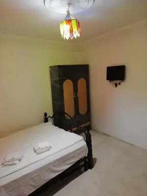 a room with a bed and a tv in it at Dar Essalam in Marrakech