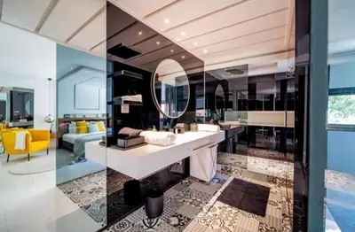 a bathroom with a sink and a living room at Appartement luxe hivernage in Marrakech
