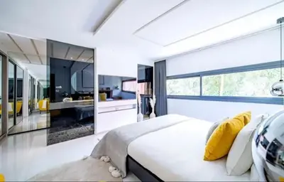 a bedroom with a large bed with yellow pillows at Appartement luxe hivernage in Marrakech