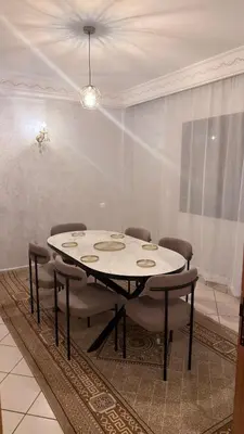 a table in a room with chairs around it at 3 bedrooms 2 balconies kitchen, salon 2 bathrooms in Marrakech