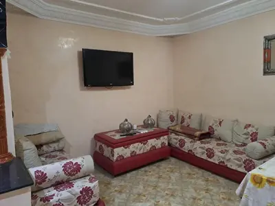 a living room with couches and a flat screen tv at Happy space in Marrakech