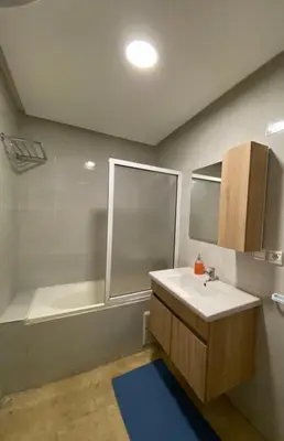 a bathroom with a white sink and a bath tub at Cosy 1 Bedroom flat marrakech city center in Marrakech